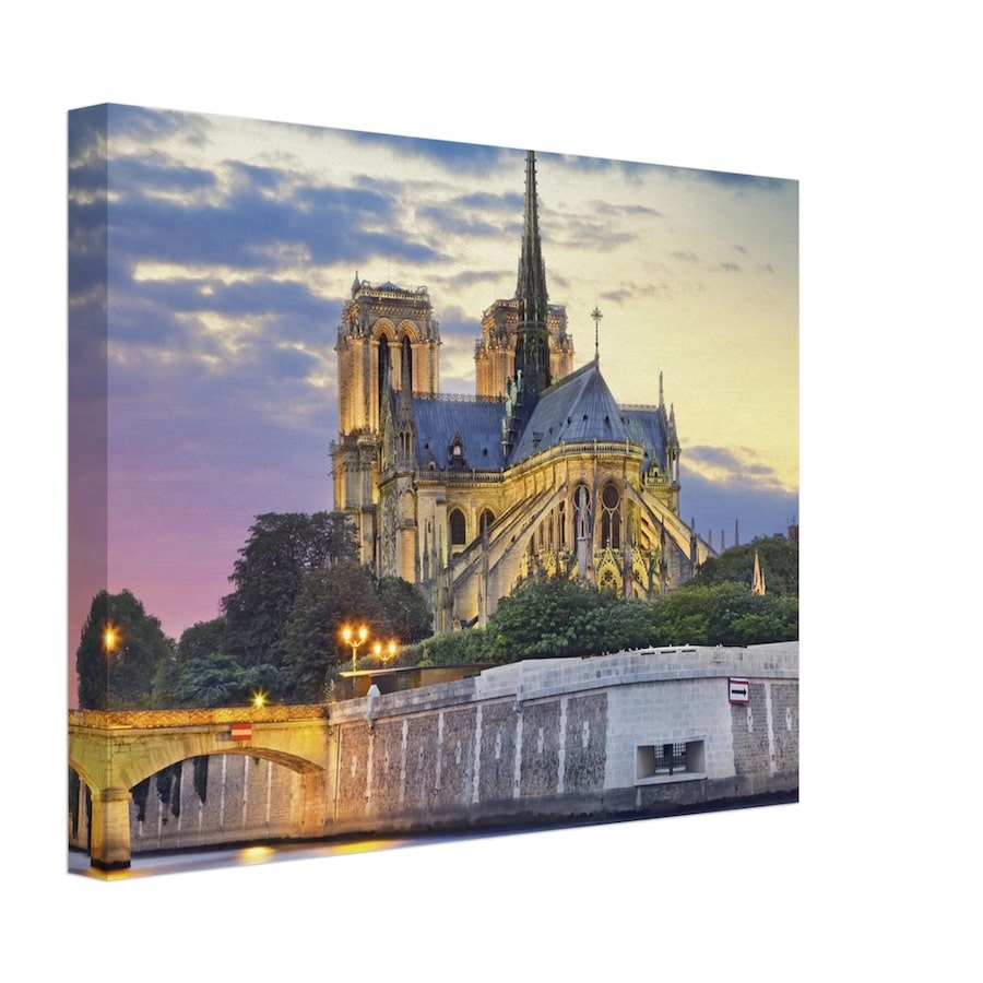 A canvas print of the Notre-Dame Cathedral illuminated at twilight, with the Seine River and a historic bridge in the foreground, showcasing the majestic beauty of this iconic Paris landmark against a dusky sky.