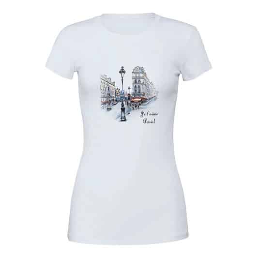 A white t-shirt depicting a detailed street scene in Paris, showing classic Parisian buildings, a lamppost, and a café terrace. The phrase "Je t'aime Paris!" enhances the romantic Parisian theme.
