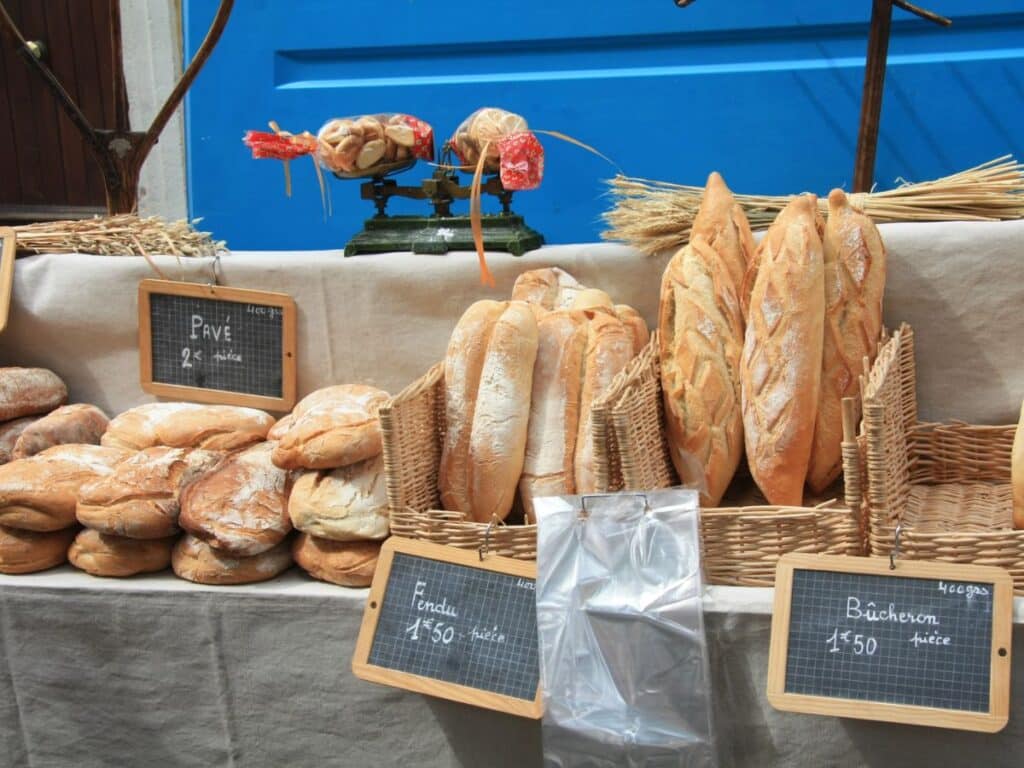 A variety of artisan bread displayed at a local French bakery, emphasizing the culinary richness that appeals to Americans moving to France for a taste of authentic European life.