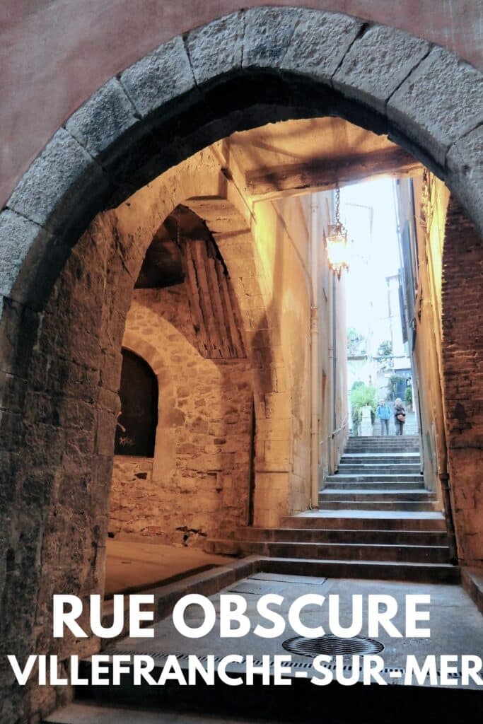 The atmospheric arches of Rue Obscure, Villefranche-sur-Mer, with stone staircases and glowing lanterns, capturing its mysterious charm.