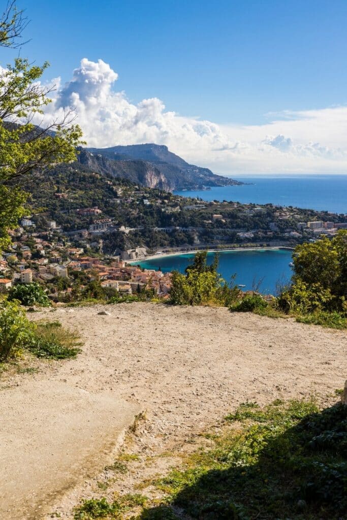 A rugged pathway near Plage des Marinieres, leading to breathtaking views of the coastline and deep blue Mediterranean waters, a tranquil hidden gem for Instagram photos.