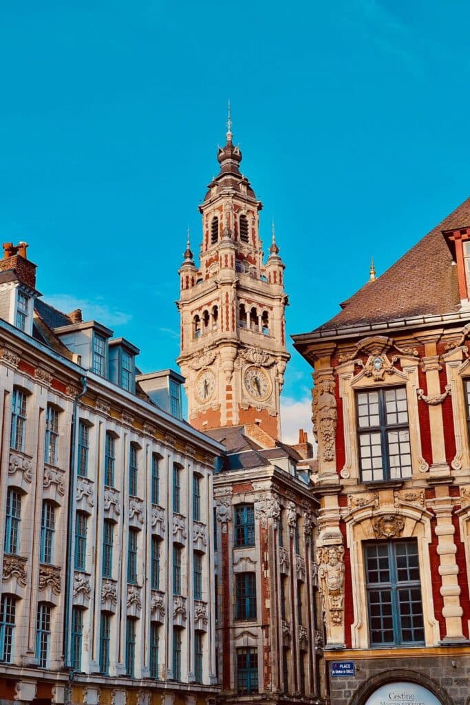 Ornate clock tower rising above historic French architecture in Lille, blending elegance and romance in the city.