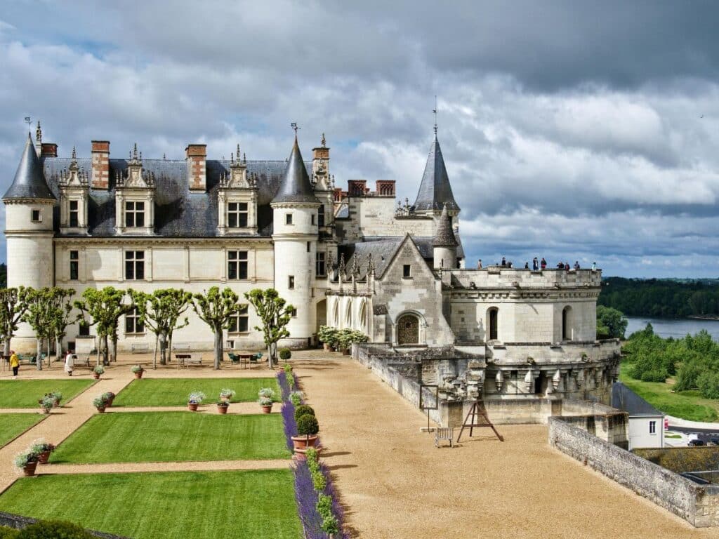 The magnificent Château d'Amboise, perched above the Loire Valley, showcasing its medieval towers, intricate stonework, and formal gardens. This historic fortress-turned-royal-residence offers breathtaking panoramic views.