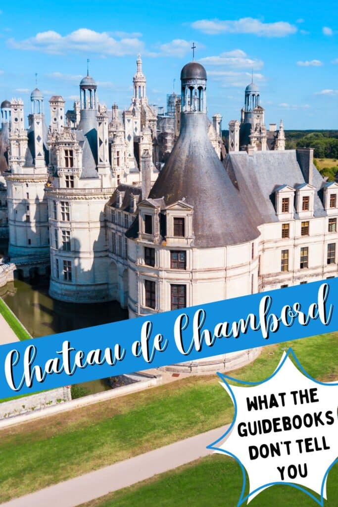A stunning aerial view of Château de Chambord, showcasing its elaborate towers, turrets, and moat under a bright blue sky. Overlaid text reads "Château de Chambord" in an elegant script on a blue banner, with a starburst graphic stating, "What the guidebooks don't tell you."