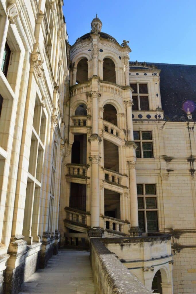 The iconic double-helix staircase of Château de Chambord, designed by Leonardo da Vinci, spirals elegantly within its grand stone tower, showcasing the castle’s architectural brilliance.