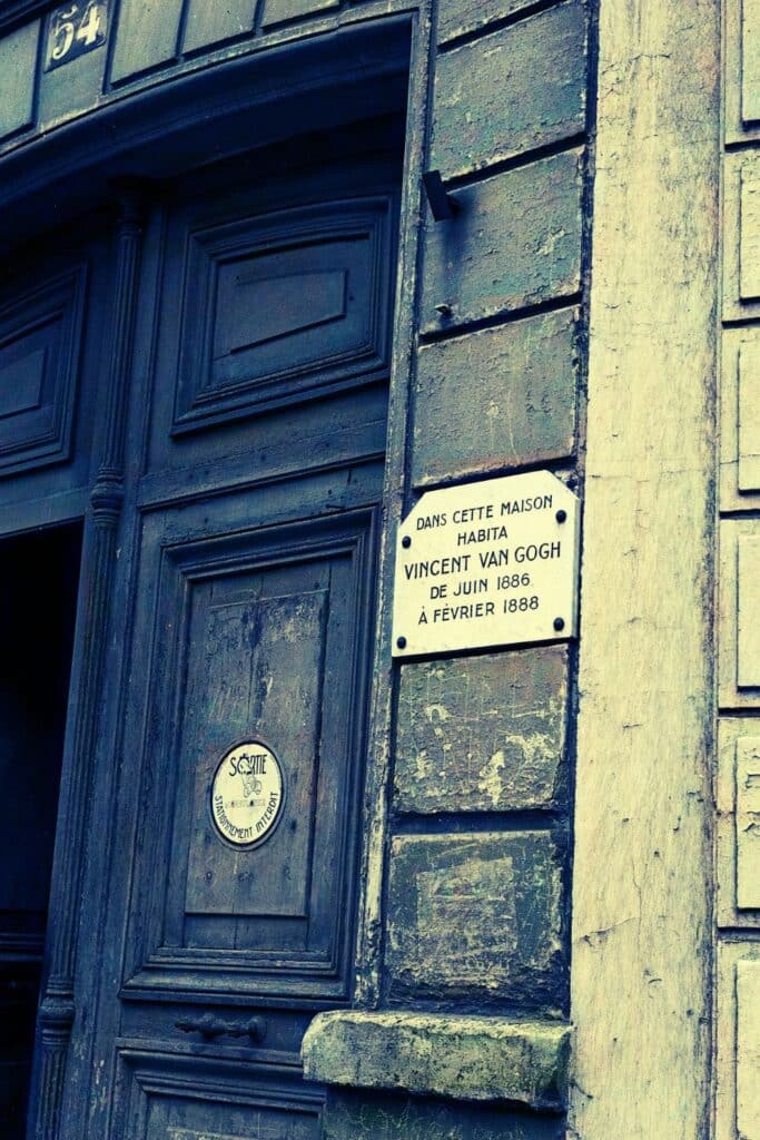 A historic doorway on Rue Lepic in Montmartre, Paris, with a plaque marking the former residence of Vincent van Gogh and his brother Theo from 1886 to 1888.