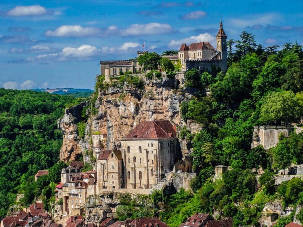 Stone arches and gothic windows are carved directly into a soaring cliffside at Rocamadour, blending natural wonder and medieval design in one of the most unique storybook towns in France.