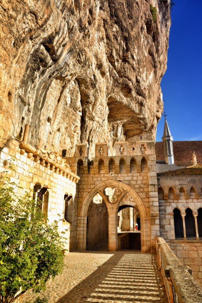 Rocamadour's historic village clings to dramatic limestone cliffs, its terracotta roofs and ancient chapels layered into the rock—fairytale perfection among storybook towns in France.
