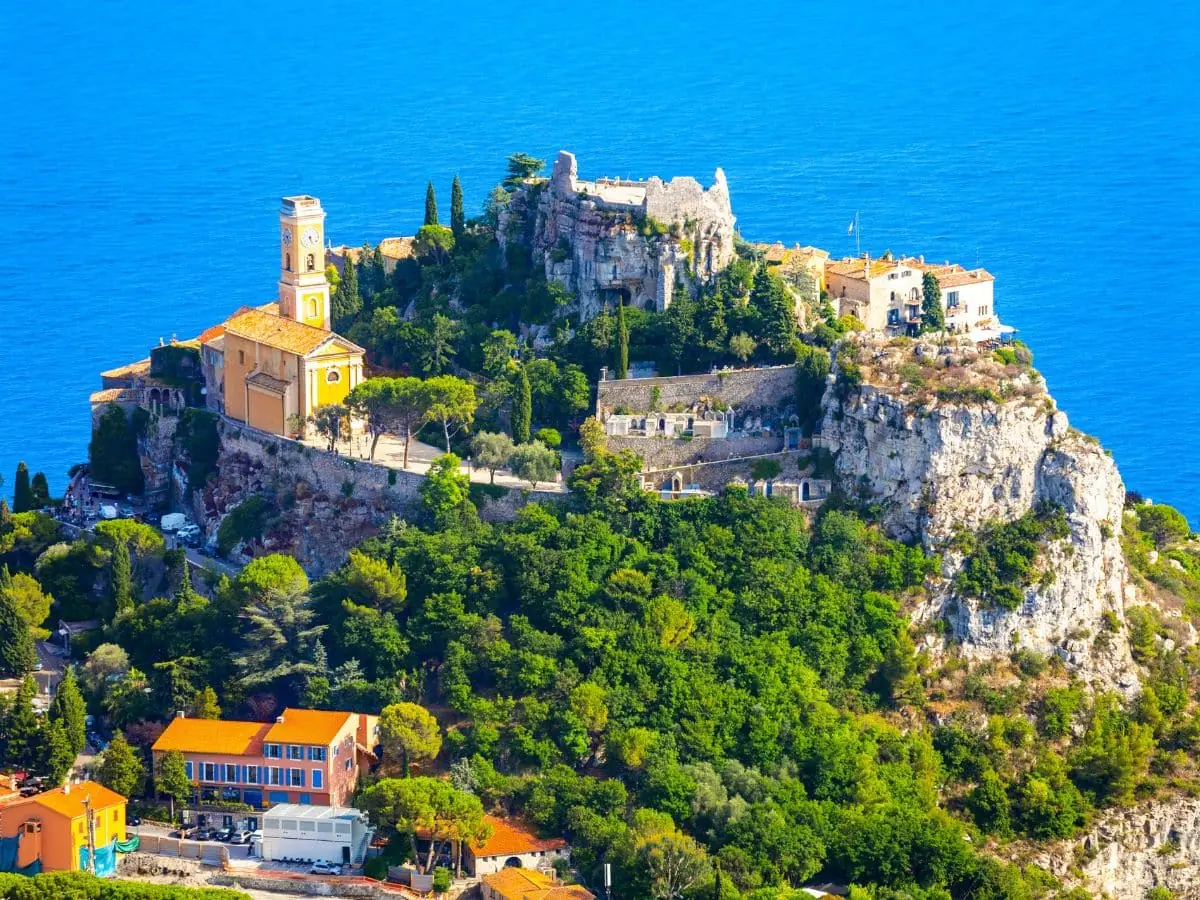 A panoramic view of Èze, a picturesque hilltop village on the French Riviera, showcasing its medieval architecture and stunning Mediterranean backdrop—skipping hidden gems like this is a common mistake when visiting the South of France.