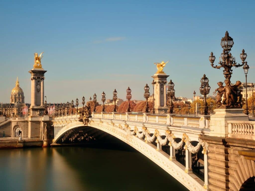 Pont Alexandre III sparkles under golden hour light, its intricate statues and lampposts capturing the elegance of Belle Époque architecture. Among the most photographed bridges in Paris.