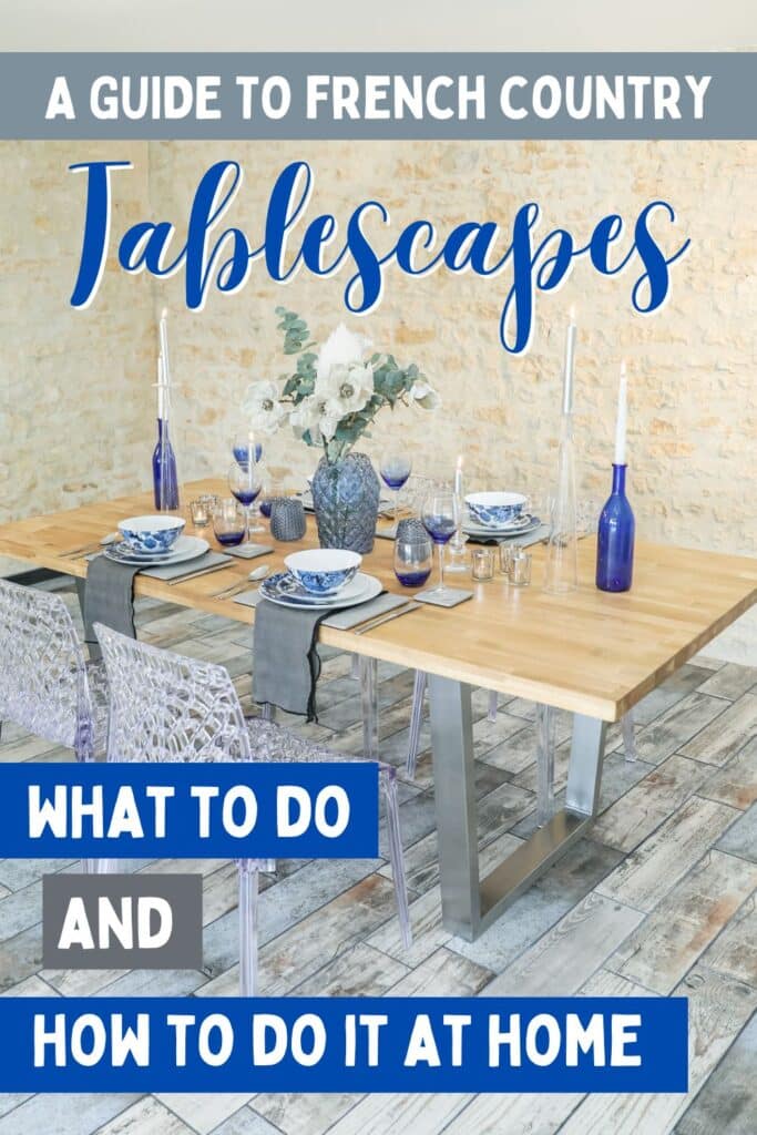 A complete French Country table decor setup featuring soft wood tones, translucent acrylic chairs, cobalt blue glass bottles, and floral plates. Text overlay reads, “A Guide to French Country Tablescapes: What to Do and How to Do It at Home.”